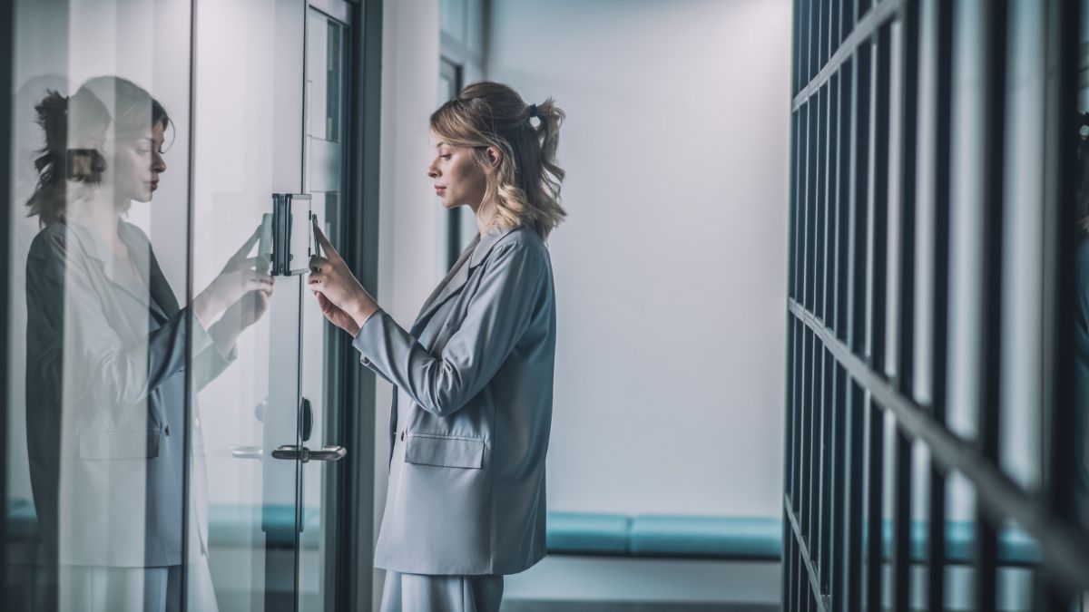 Woman opening door with smartphone